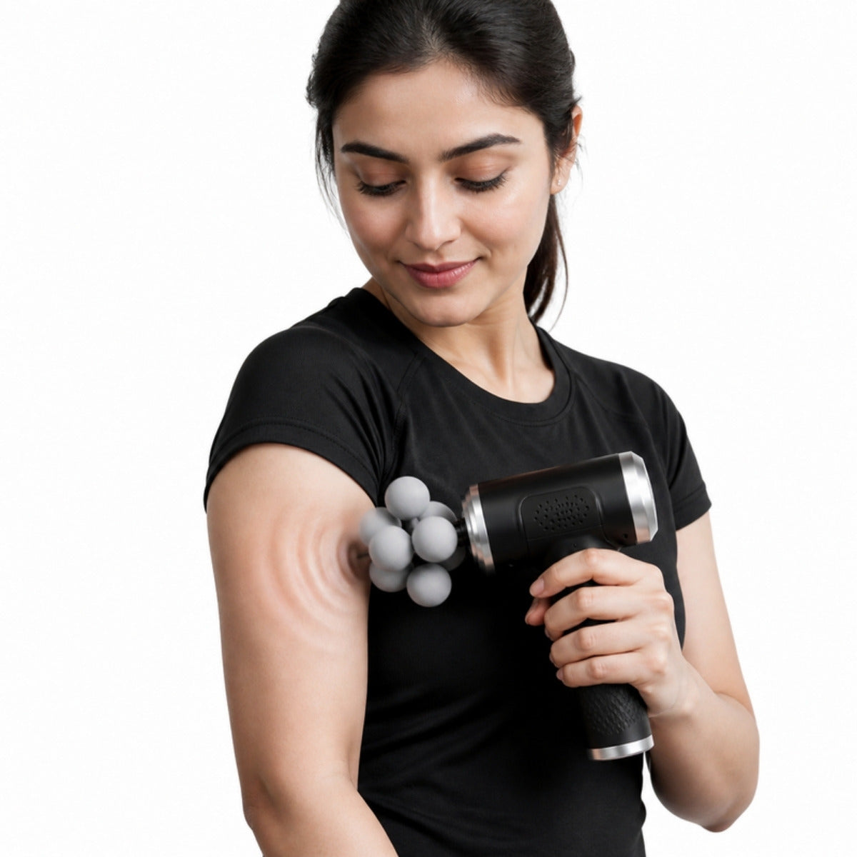 Woman using BLD-780 massage gun on upper arm with visible muscle ripple