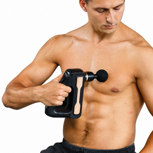 Man using 8 heads heated and cold massage gun on chest muscle