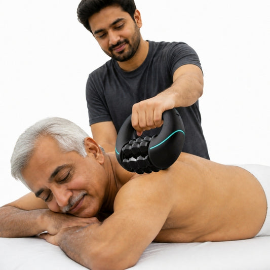 Son holding electric roller massager by the handle on father's back